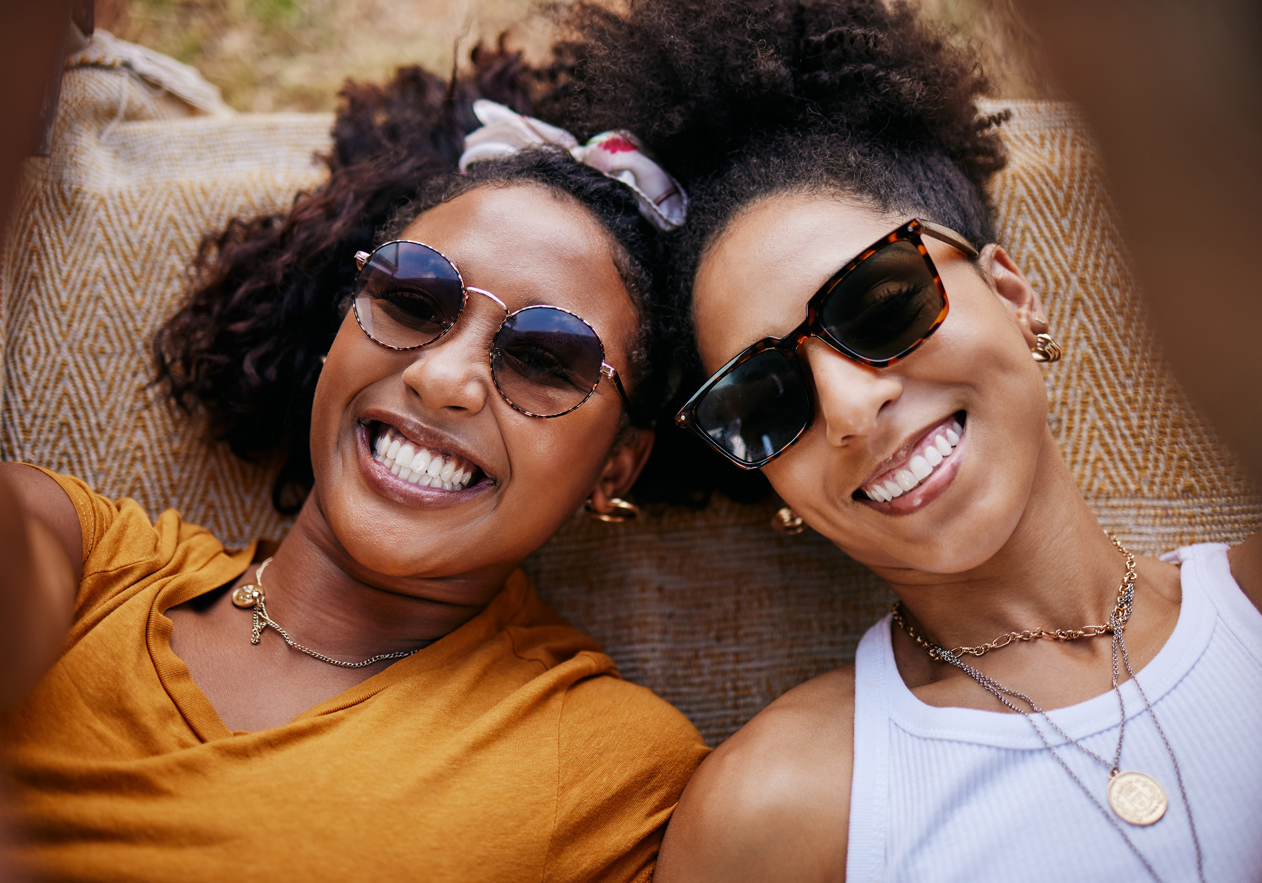 two girls with sunglasses smiling - Timber Ridge Dental