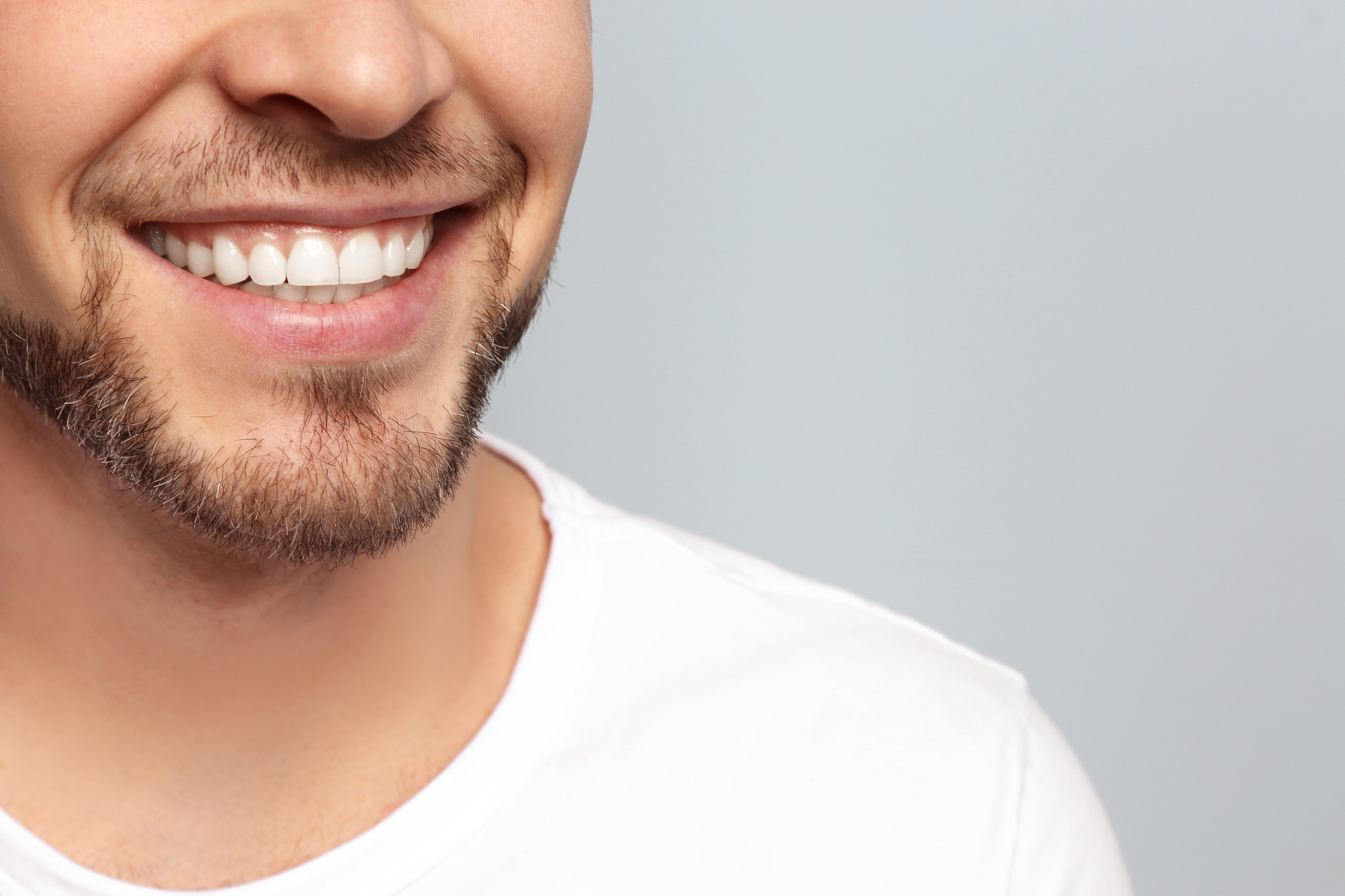 Man smiling with his results from Exion and Emface treatment at Timber Ridge Dental Center