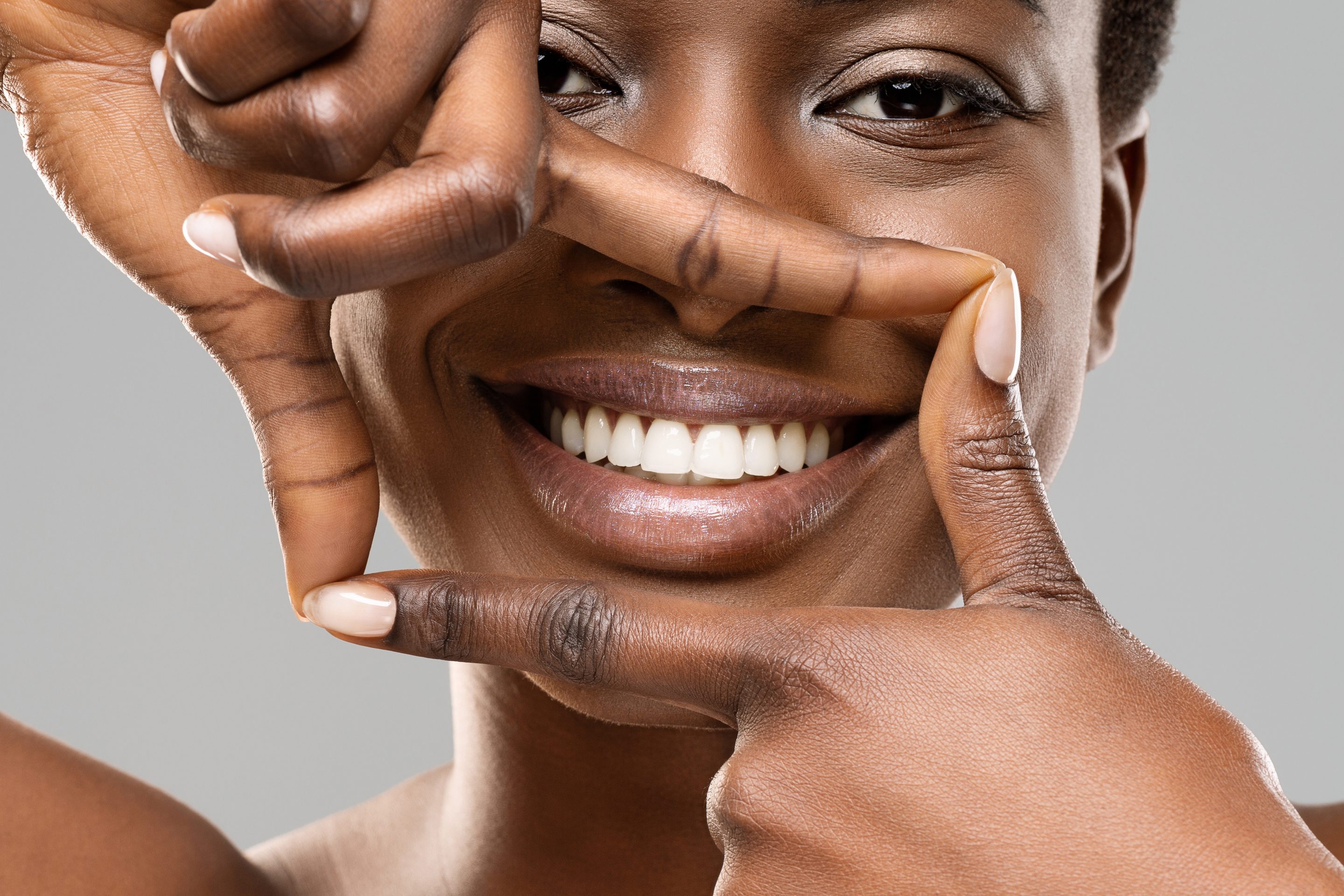 woman showing her whitened smile after cosmetic dental care in Dawsonville GA